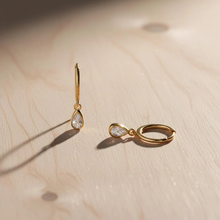 Load image into Gallery viewer, Sterling silver teardrop huggie earrings with dainty CZ stones, Luxe Treasures jewelry, close-up view of elegant hoop earrings.