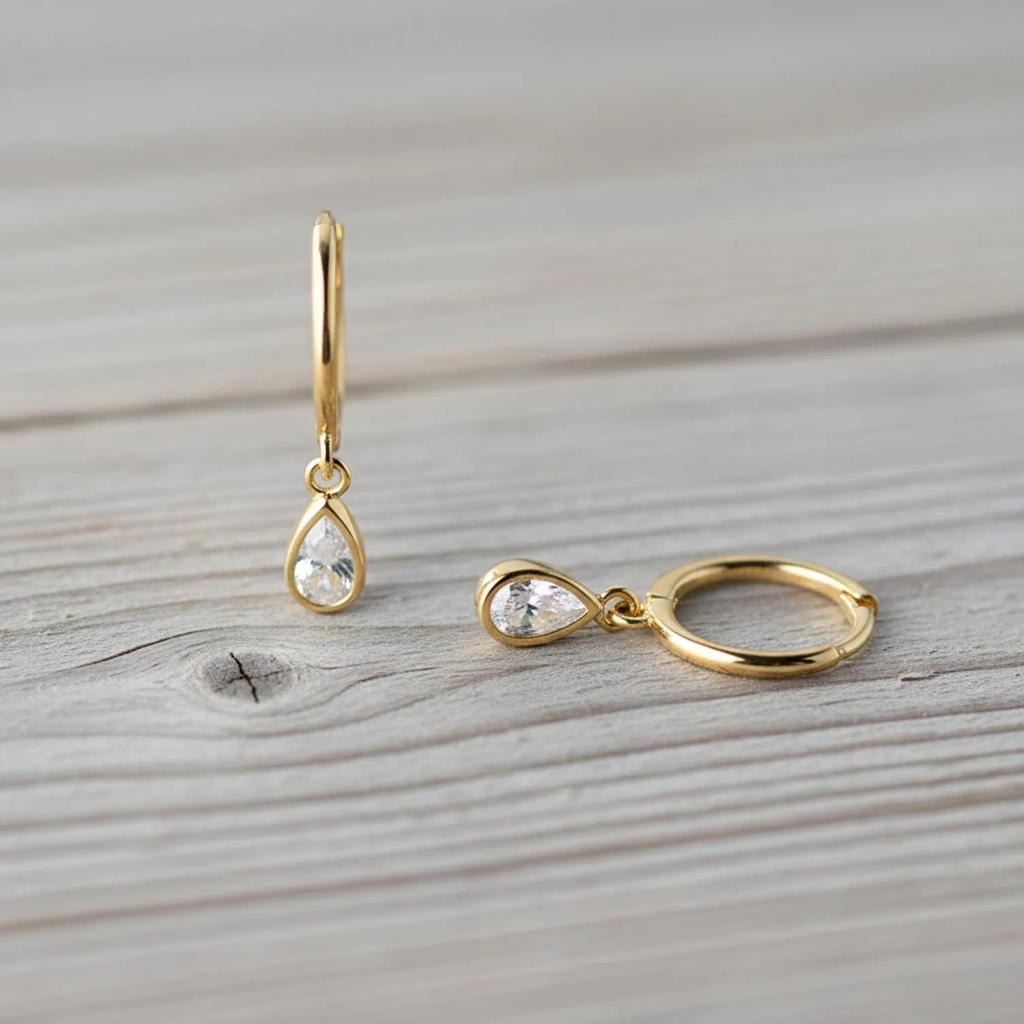 Sterling silver teardrop huggie earrings with dainty cubic zirconia accents, stylish hoop jewelry from Luxe Treasures.