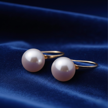 Load image into Gallery viewer, Sterling silver and gold handmade pearl huggie earrings with a sleek, minimalist design for elegant jewelry styling.