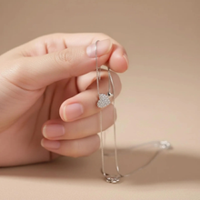 Load image into Gallery viewer, Sterling silver heart pendant necklace with zirconia stones on a delicate clavicle chain, shown on a white background.