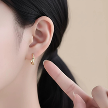 Load image into Gallery viewer, Sterling silver twisted huggie hoop earrings with gold plating, small dainty hoops, stylish and elegant jewelry by Luxe Treasures.