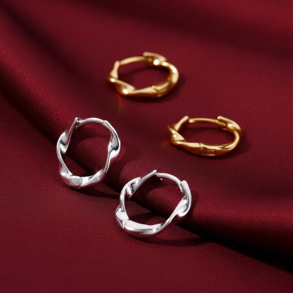 Sterling silver twisted huggie hoop earrings with gold plating, delicate and dainty jewelry for pierced ears.