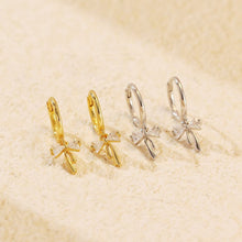 Load image into Gallery viewer, Sterling silver Ribbon Bow Huggie Earrings with dainty bow dangle design, Luxe Treasures jewelry, stylish hoop earrings for women