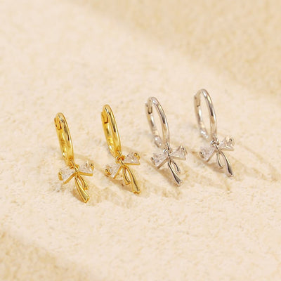 Sterling silver Ribbon Bow Huggie Earrings with dainty bow dangle design, Luxe Treasures jewelry, stylish hoop earrings for women