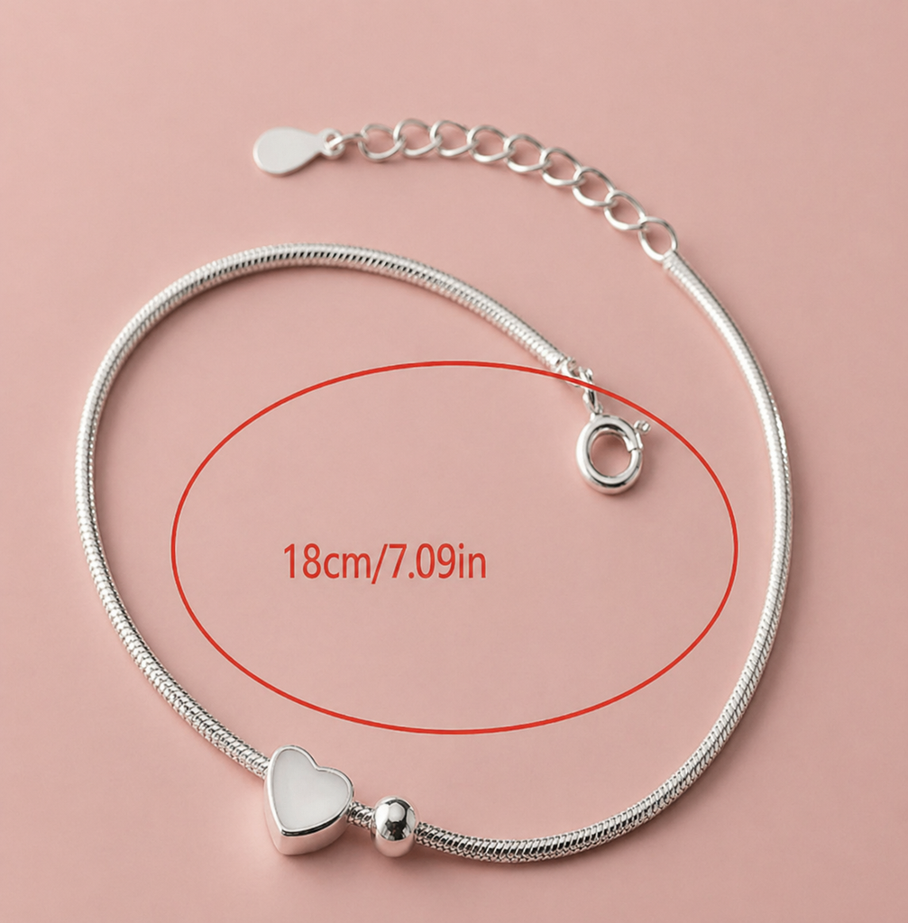 Dainty vintage-style sterling silver round bead heart bracelet with delicate design, showcasing intricate silver craftsmanship.
