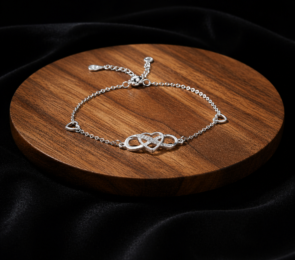 Sterling silver heart bracelet by Luxe Treasures showing a delicate, adjustable minimalist jewelry design on a neutral background.