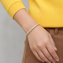 Load image into Gallery viewer, Gold tennis bracelet with sparkling zirconia stones, luxury jewelry piece, featuring intricate design and elegant craftsmanship.