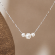 Load image into Gallery viewer, Dainty gold necklace with three freshwater pearls, minimalist layering jewelry by Luxe Treasures, displayed on a neutral background.