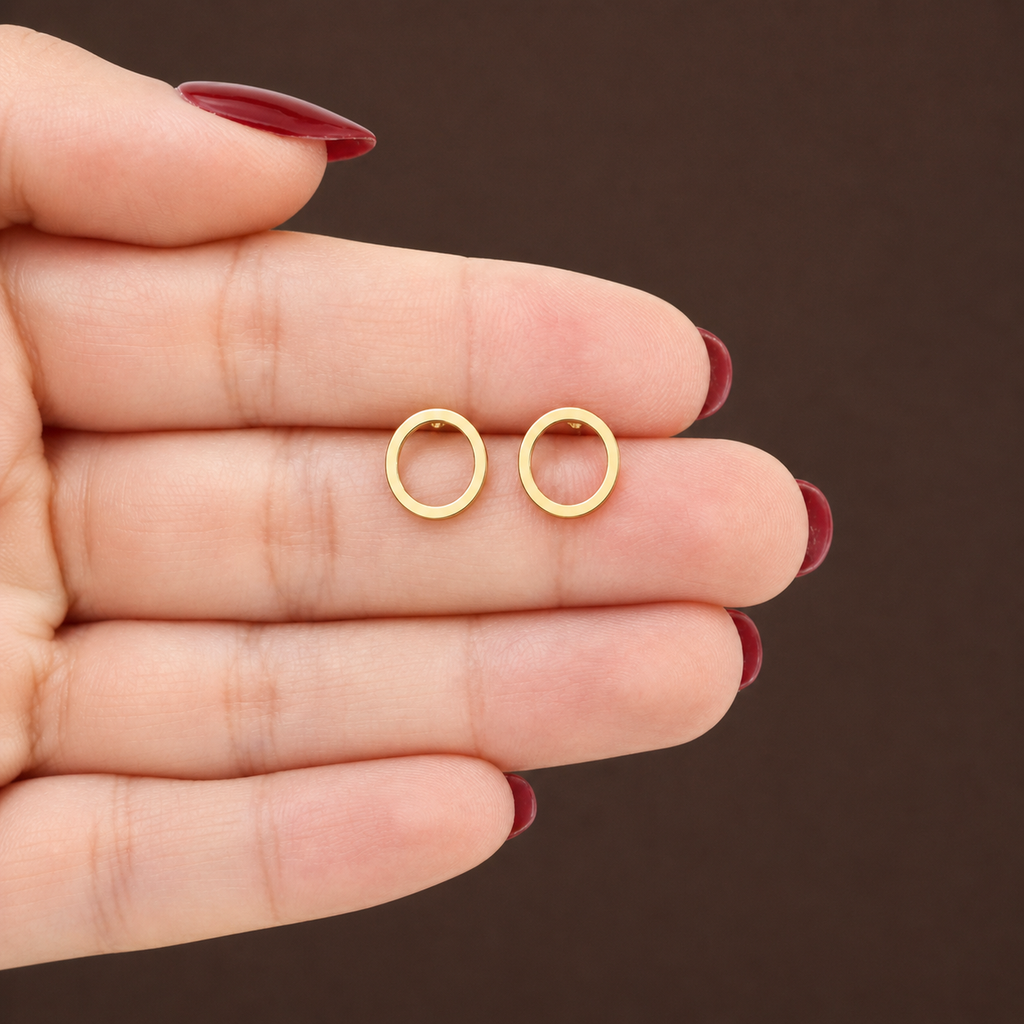 Minimalist open circle stud earrings in gold, silver, and black from Luxe Treasures, showcasing sleek, modern jewelry design