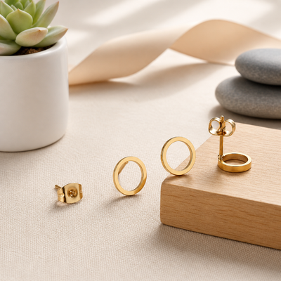 Open circle stud earrings in gold, silver, and black with a minimalist design, featuring Luxe Treasures' sleek jewelry style.