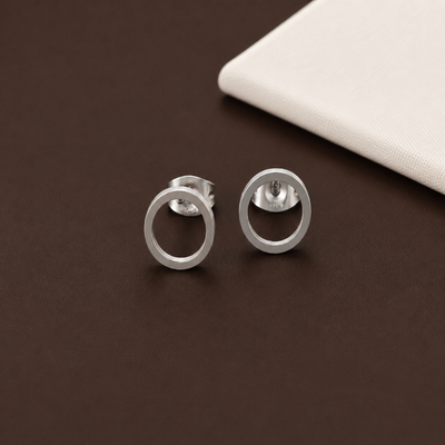 Minimalist open circle stud earrings in gold, silver, and black from Luxe Treasures, showcasing sleek and modern jewelry design.