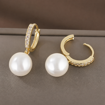 Elegant vintage pearl drop earrings by Luxe Treasures featuring dangle style with lustrous pearls and intricate detailing.