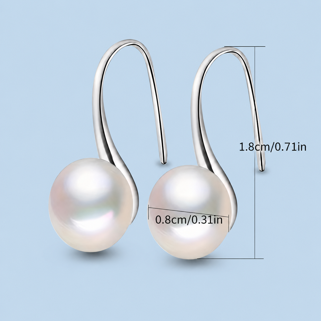 Handmade pearl huggie earrings in sterling silver and gold, featuring elegant pearl accents and smooth hoop design.