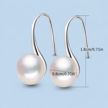 Load image into Gallery viewer, Handmade pearl huggie earrings in sterling silver and gold, featuring elegant pearl accents and smooth hoop design.