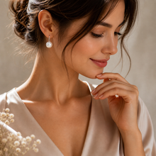 Load image into Gallery viewer, Handmade pearl huggie earrings with sterling silver and gold accents, featuring small, elegant pearls on a polished metal hoop.