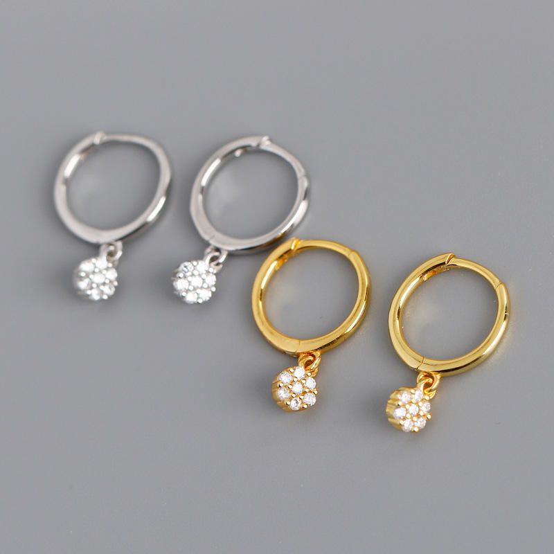 Gold diamond huggie hoop earrings for women, featuring dainty drop dangle design, suitable for minimalist bridal jewelry.