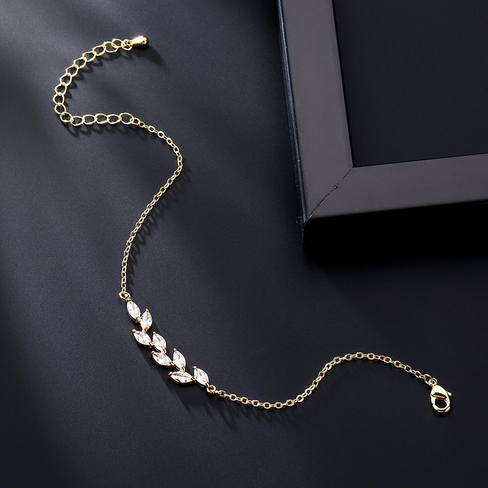 Dainty Leaf Marquise CZ bracelet from Luxe Treasures, minimalist bridal jewelry featuring delicate leaf and marquise-shaped CZ stones.