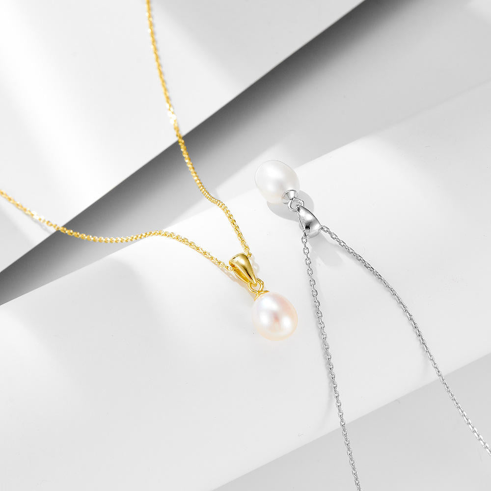 Gold teardrop pearl necklace with freshwater pearl pendant from Luxe Treasures, close-up of elegant jewelry piece.
