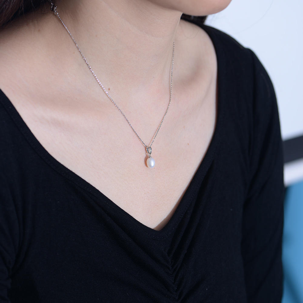 Gold teardrop pearl necklace with freshwater pearl pendant, showcasing elegant jewelry design by Luxe Treasures.
