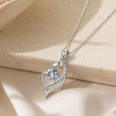 Sterling silver moissanite necklace with a 0.5 carat pendant, dainty jewelry from Luxe Treasures, displayed on a white background.