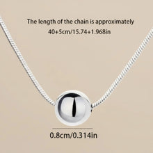 Load image into Gallery viewer, Sterling silver ball necklace on snake bone chain, minimalist boho jewelry by Luxe Treasures, close-up view of chain and pendant.