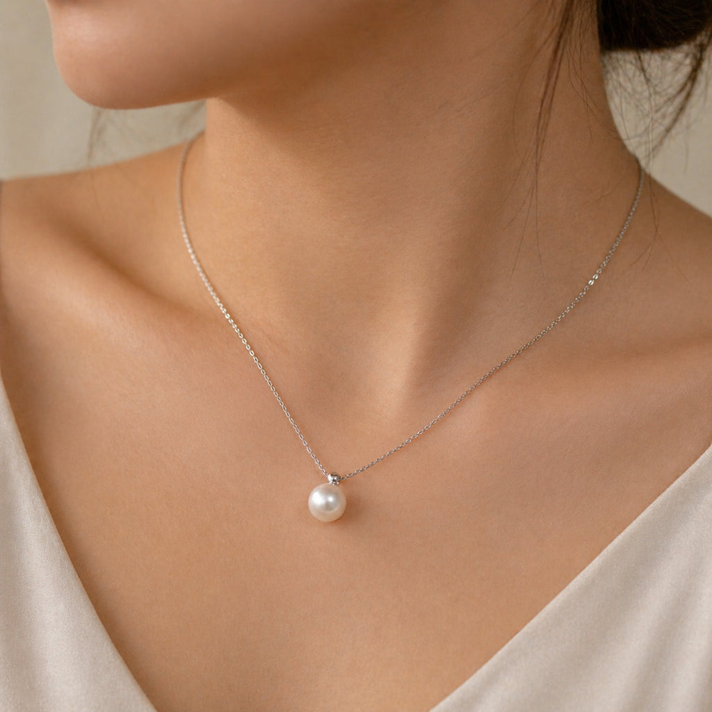 Sterling silver necklace with a fresh water shell pearl pendant, minimalist design by Luxe Treasures.