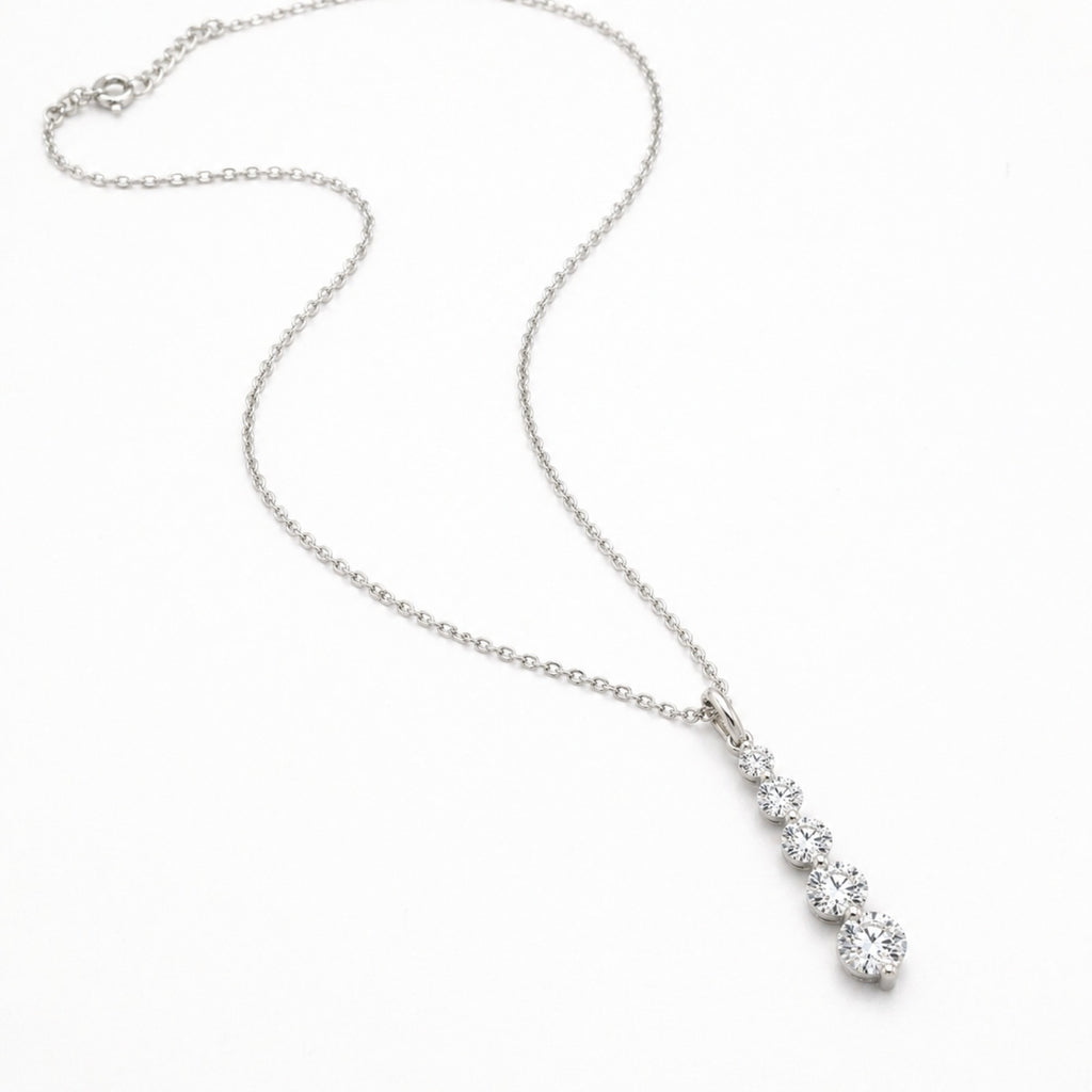 Dainty sterling silver CZ charm necklace with a French pendant, showcasing elegant jewelry design by Luxe Treasures.