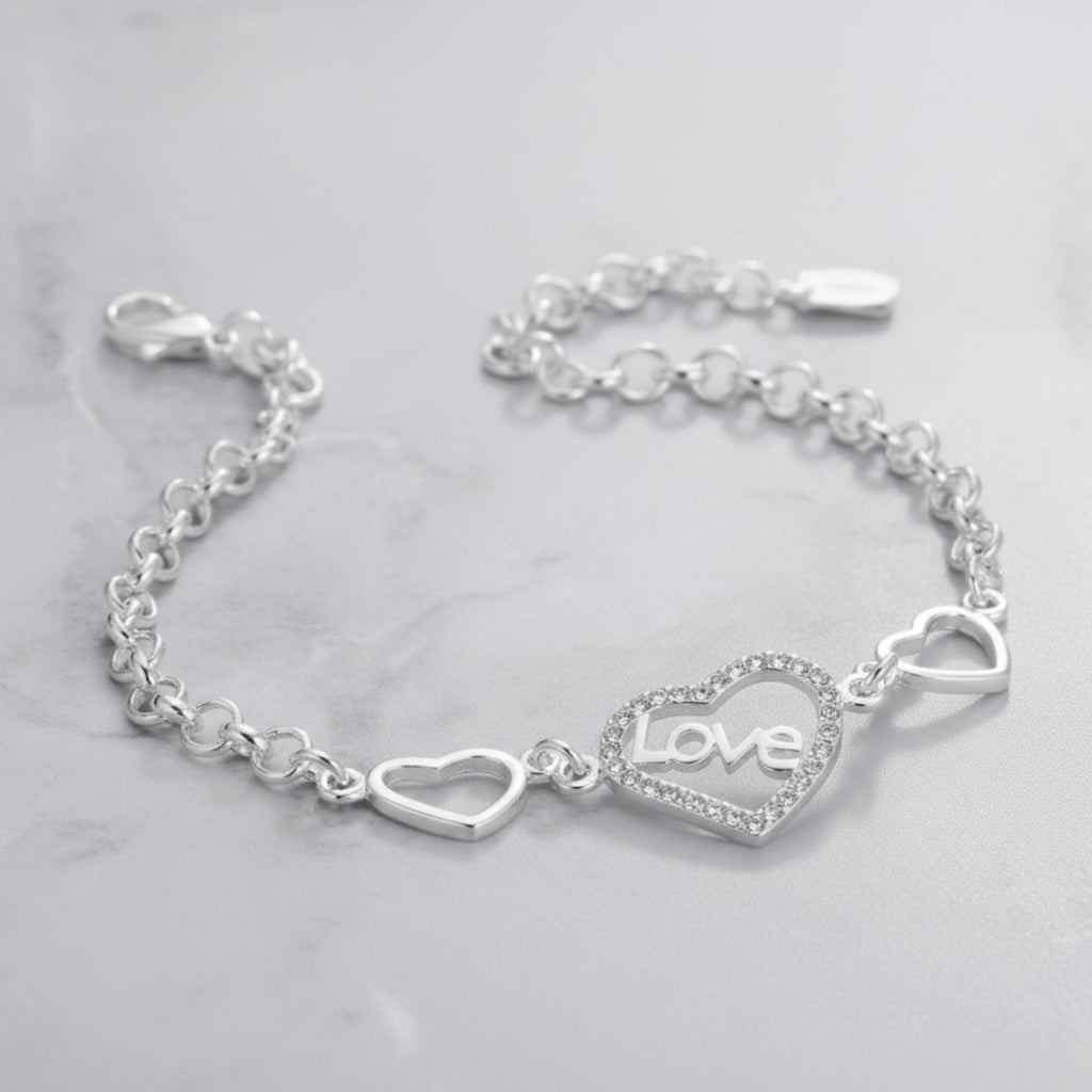 Sterling silver love heart bracelet with geometric chain design by Luxe Treasures, featuring delicate heart and chain links.