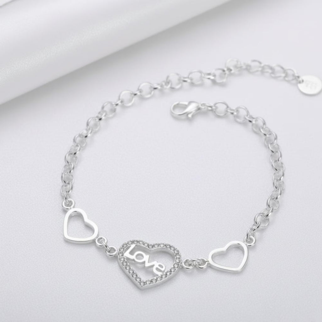 Sterling silver love heart bracelet with geometric chain design, featuring intricate links and a polished finish.