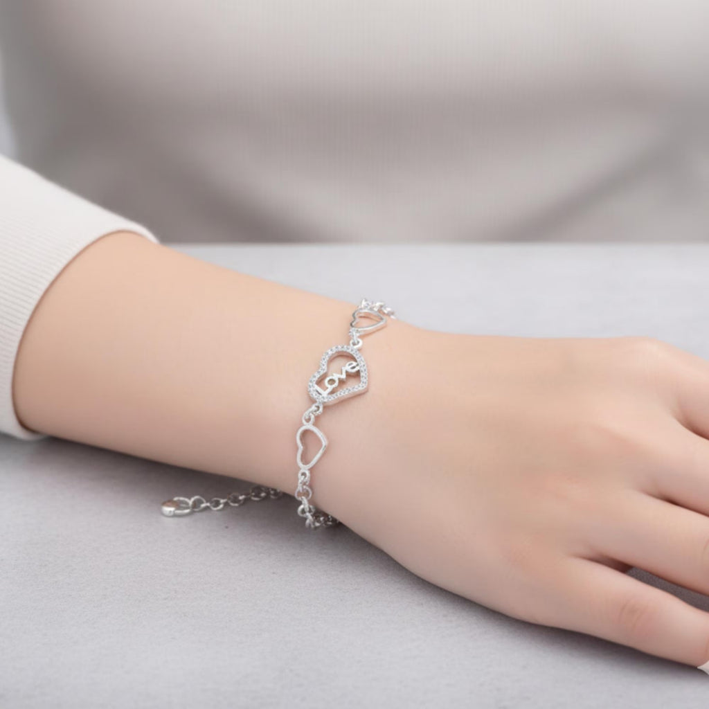 Sterling silver love heart bracelet with geometric chain design, featuring a delicate and stylish jewelry piece by Luxe Treasures.