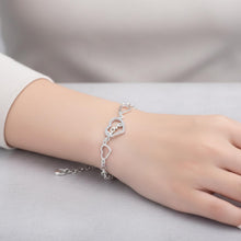 Load image into Gallery viewer, Sterling silver love heart bracelet with geometric chain design, featuring a delicate and stylish jewelry piece by Luxe Treasures.