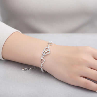 Sterling silver love heart bracelet with geometric chain design, featuring a delicate and stylish jewelry piece by Luxe Treasures.