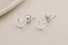Load image into Gallery viewer, Silver heart-shaped stainless steel stud earrings featuring a minimalist design, perfect for everyday jewelry.