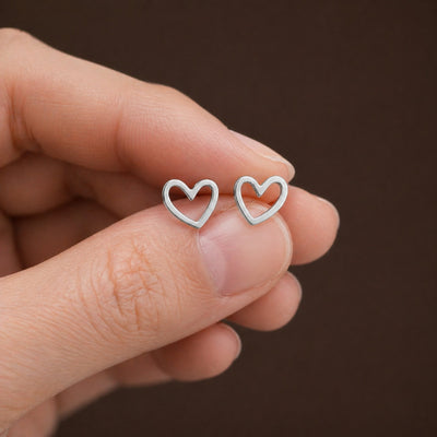 Stainless steel heart stud earrings with minimalist design, featuring small, shiny heart shapes for elegant everyday wear.
