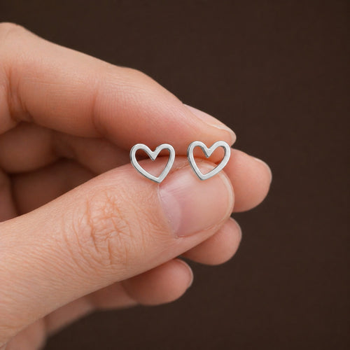 Stainless steel heart stud earrings with minimalist design, featuring small, shiny heart shapes for elegant everyday wear.
