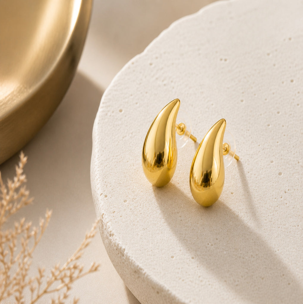 Gold teardrop stud earrings with a minimalist high-polish finish, featuring chunky statement jewelry design from Luxe Treasures.