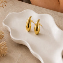 Load image into Gallery viewer, Gold teardrop stud earrings with a minimalist high-polish finish, featuring bold statement jewelry design by Luxe Treasures.