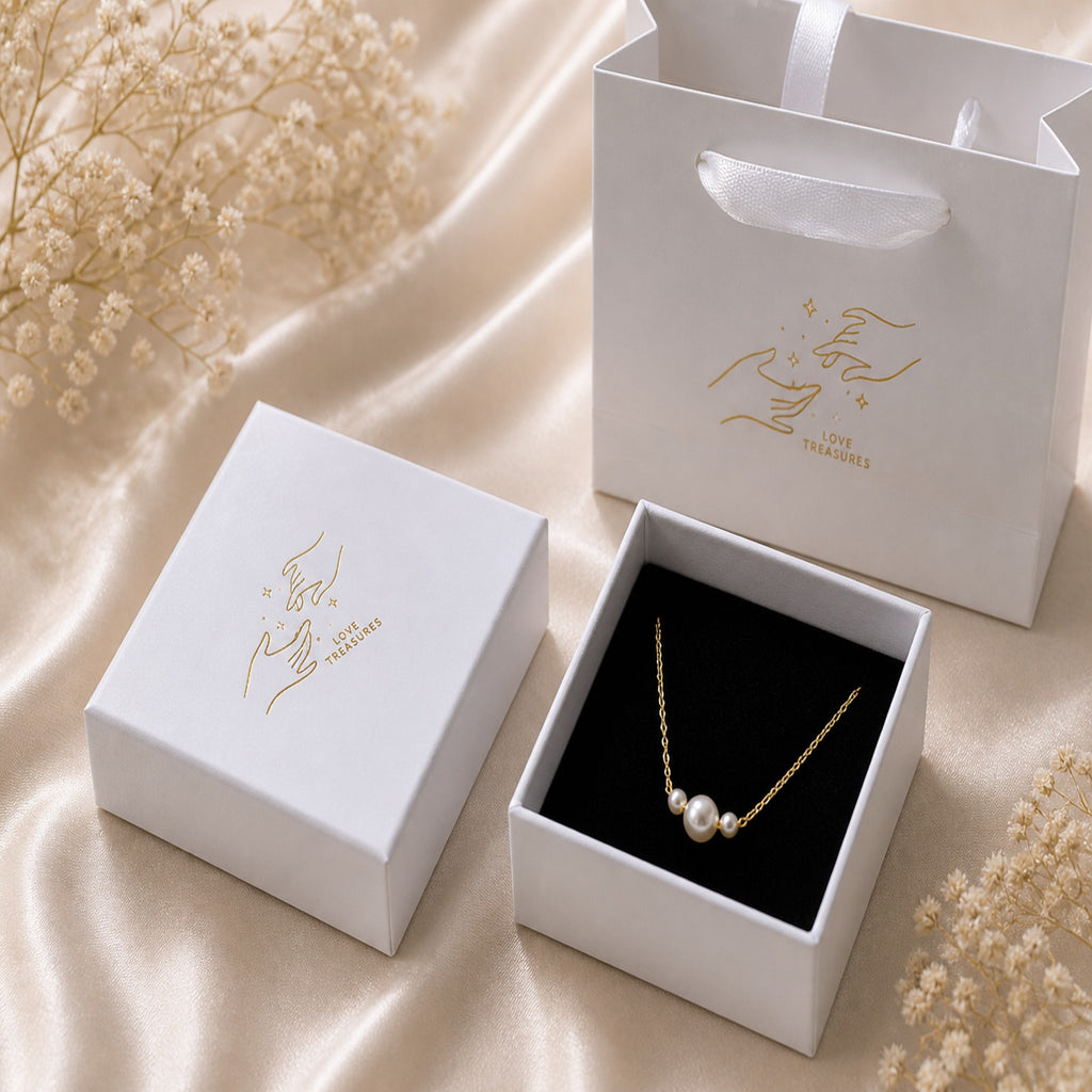 Dainty gold necklace with three freshwater pearls, minimalist layering jewelry by Luxe Treasures displayed on a white background.