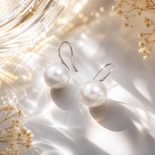 Load image into Gallery viewer, Handmade pearl huggie earrings in sterling silver and gold with delicate design, showcasing elegant jewelry craftsmanship.
