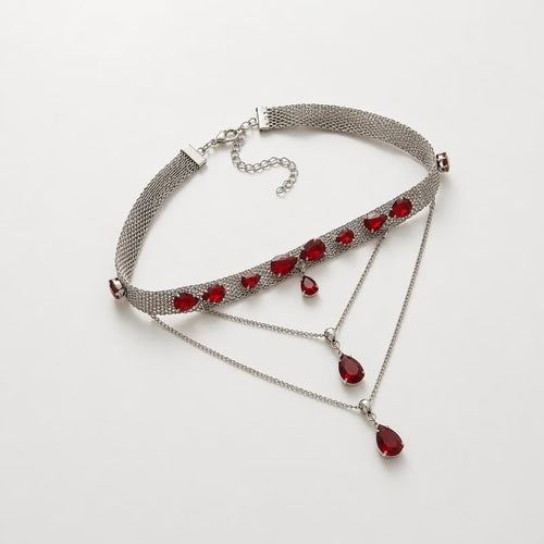 Silver choker necklace with red crystals, statement jewelry for women, featuring a sleek design and bold red accents.