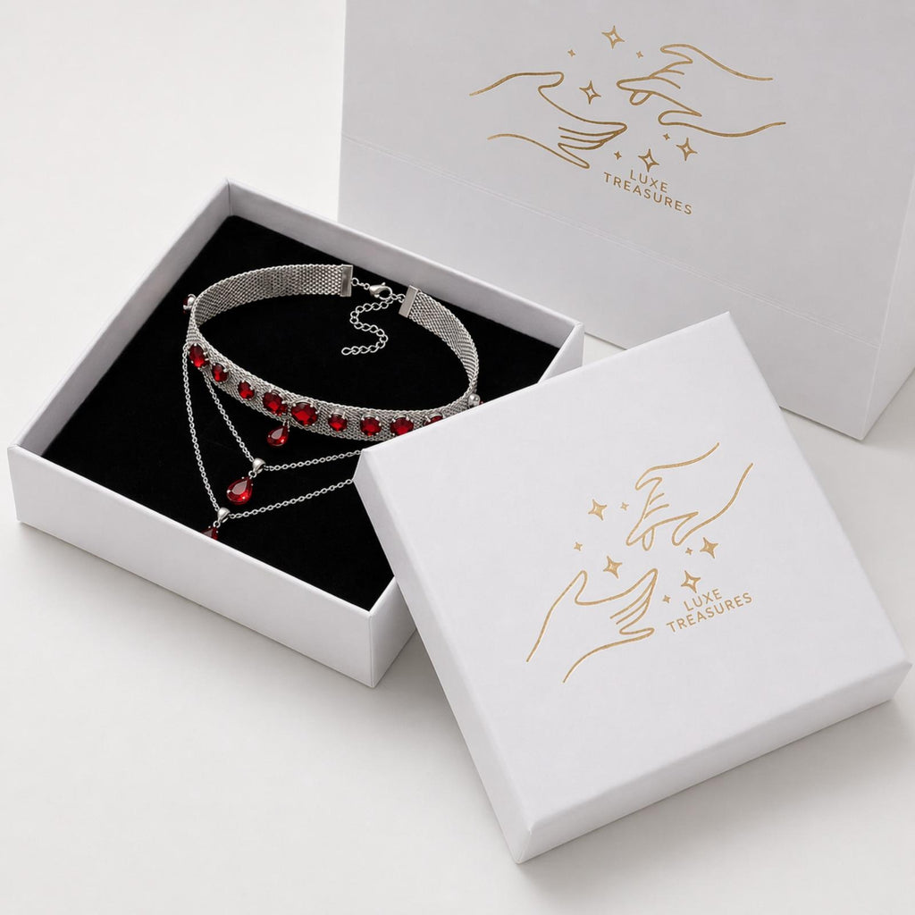 Silver choker necklace with red crystals, statement jewelry for women by Luxe Treasures, featuring a sleek design and vibrant accents.