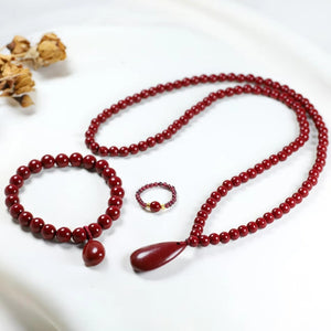 Handcrafted red beaded teardrop jewelry set including necklace, bracelet, and ring from Luxe Treasures, featuring intricate beadwork.