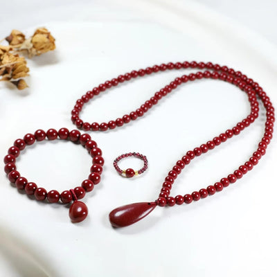 Handcrafted red beaded teardrop jewelry set including necklace, bracelet, and ring from Luxe Treasures, featuring intricate beadwork.