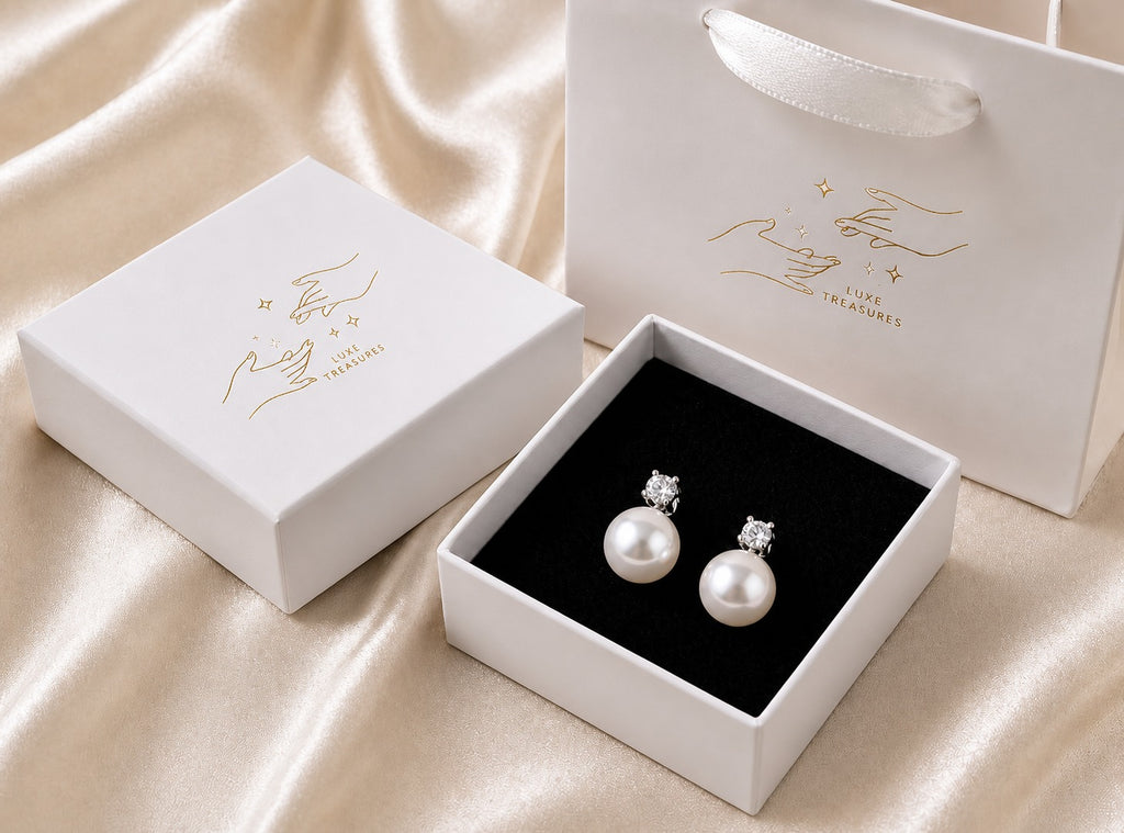 Elegant pearl drop earrings by Luxe Treasures featuring retro-inspired dangle design on shiny metal hooks.