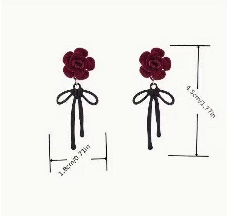 Romantic red rose earrings with black ribbon, floral dangle jewelry for women by Luxe Treasures, featuring intricate flower and ribbon details.