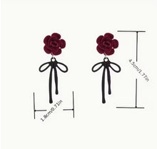 Load image into Gallery viewer, Romantic red rose earrings with black ribbon, floral dangle jewelry for women by Luxe Treasures, featuring intricate flower and ribbon details.