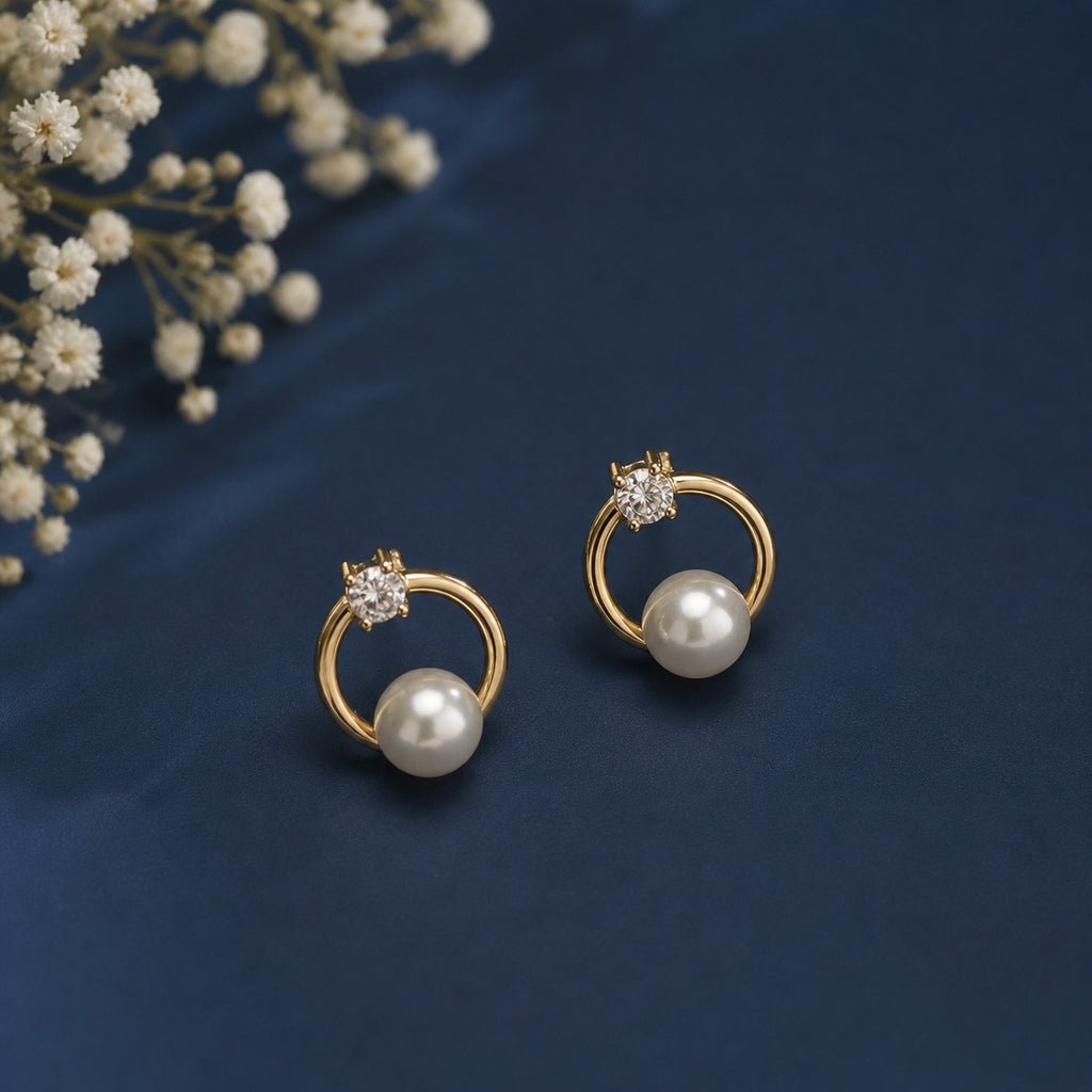 Gold circle dangle earrings featuring sparkling CZ stones and pearls