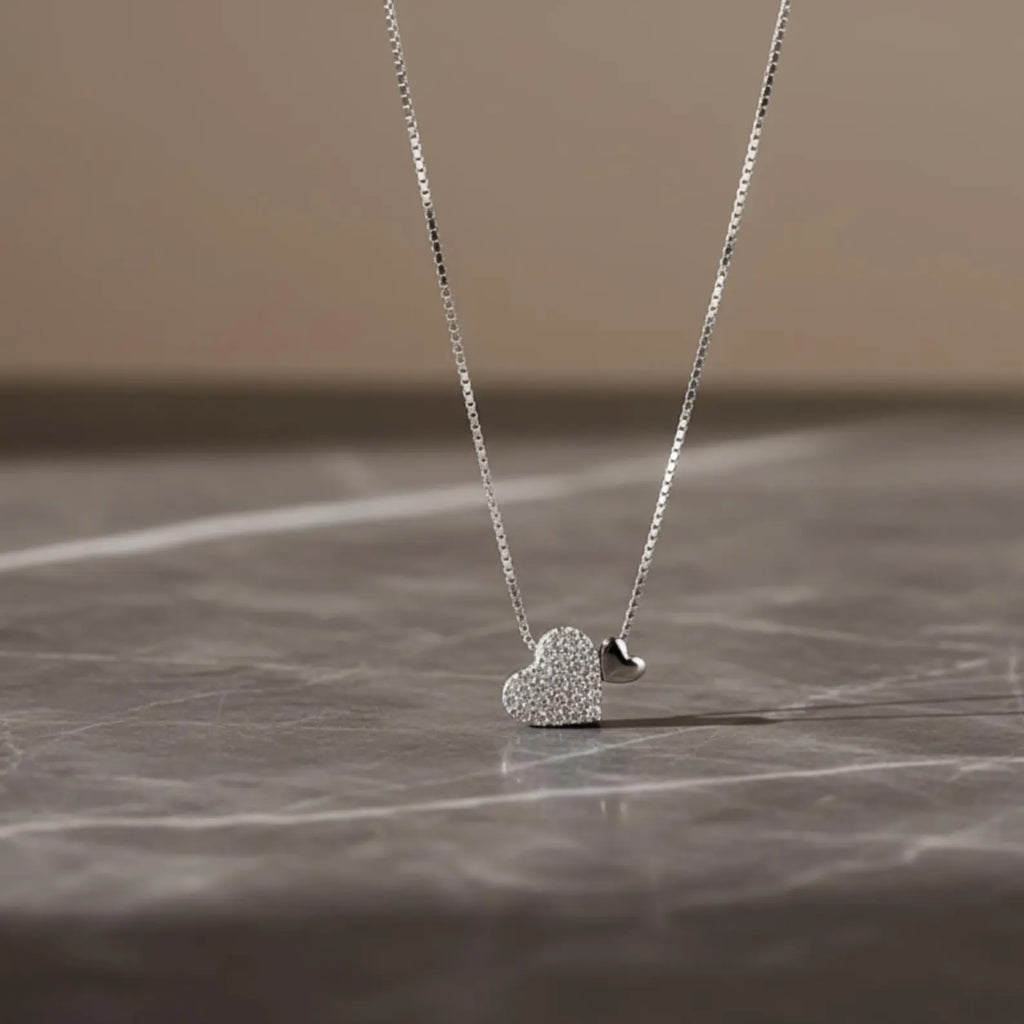 Sterling silver heart pendant necklace with zirconia on a delicate clavicle chain, designed by Luxe Treasures.