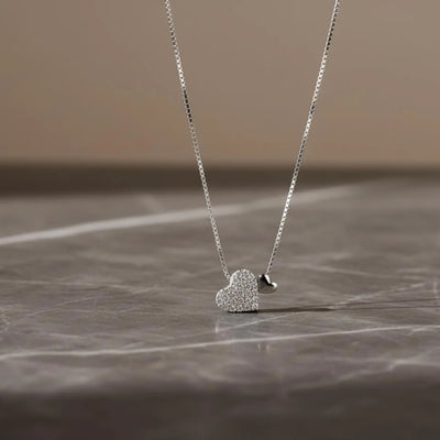 Sterling silver heart pendant necklace with zirconia on a delicate clavicle chain, designed by Luxe Treasures.