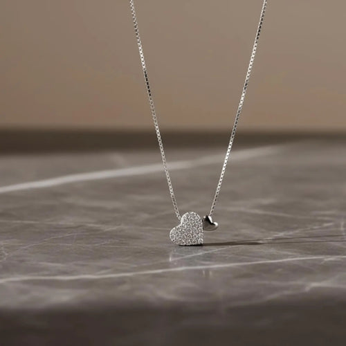 Sterling silver heart pendant necklace with zirconia on a delicate clavicle chain, designed by Luxe Treasures.